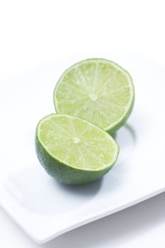 Fresh limes on white plate