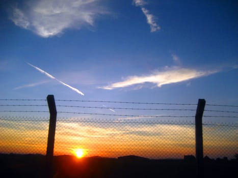 a beautiful sunset inside the fence