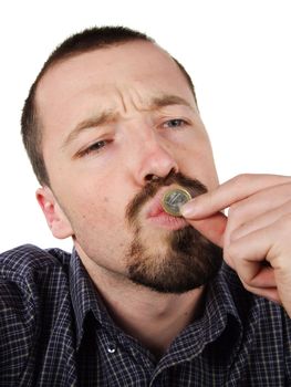Young Caucasian male portrait. Adult man is kissing a coin, happy of his hard earned money. Savings concept.