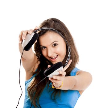 Beautiful and happy young girl holding headphones, isolated on white