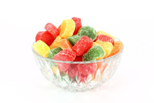 Colorful jelly candies in glass bowl isolated on white