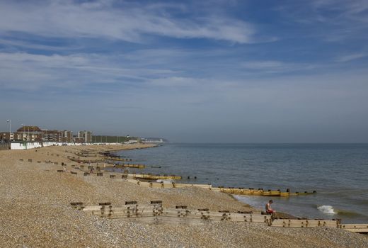 A view of a pebble beach with a blue sky