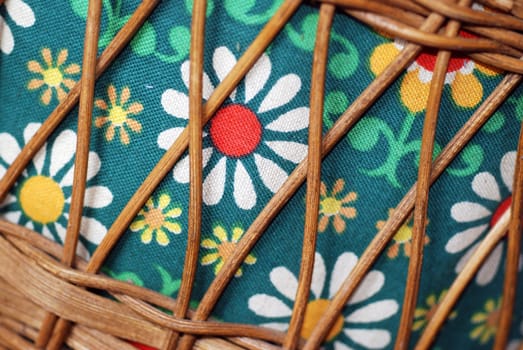 A close-up of a 1970s flower power sewing box with wicker basket.