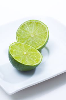 Fresh limes on white plate