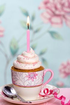 Pink birthday cupcake in a teacup