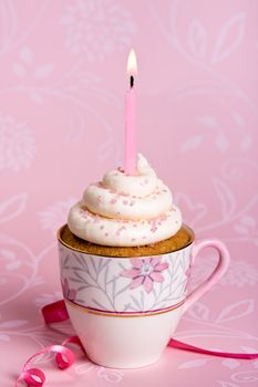 Pink birthday cupcake in a teacup