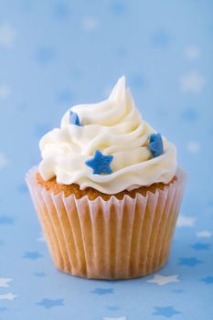 Cupcake decorated with blue sugar stars