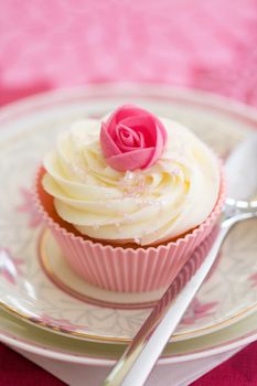 Pink rosebud cupcake, ready to eat