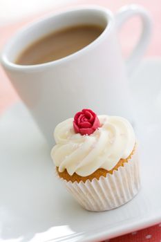Coffee and cupcake on a white plate