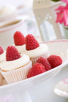 Mini cupcakes with raspberries and cream