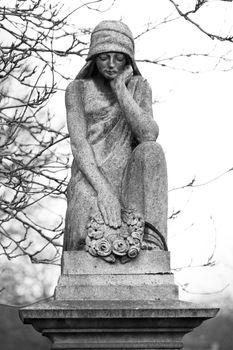 Statue adorning the top of a gravestone