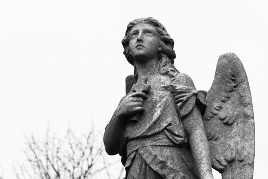 Statue adorning a grave looks heavenward