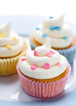 Three colorful cupcakes on a plate