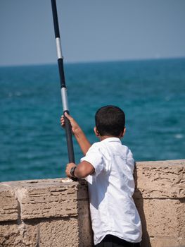 Boy fishing in Tel Aviv Israel