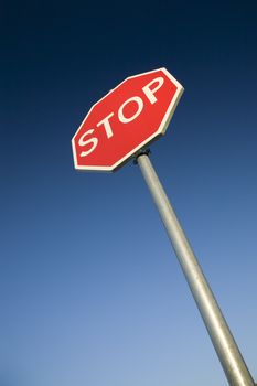 Stop sign against deep blue sky.