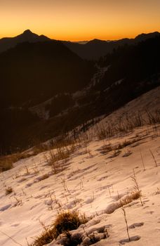 Sunrise mountain scenery with snow in winter morning.