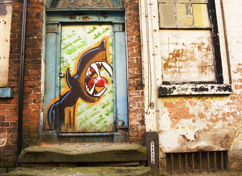 derelict doorway covered in graffiti