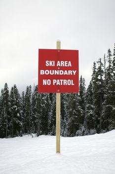 Boundary sign at ski slope warning of no patrol.