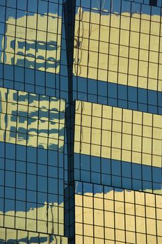 Abstract close-up of side of urban building reflecting sunlight.