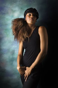 Studio portrait of hip African-American young adult woman looking at viewer.