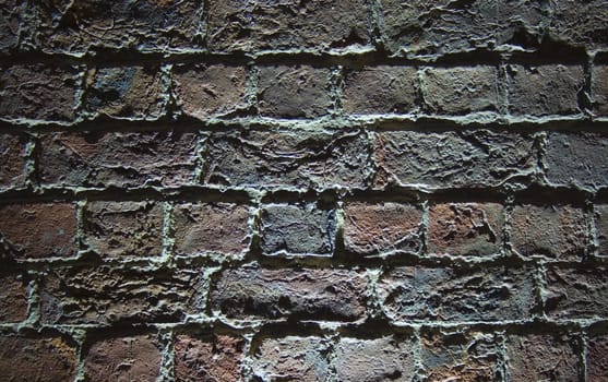 Very old (1854) brick wall with light shining from below