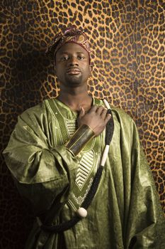 Portrait of African- American mid-adult man wearing traditional African clothing.