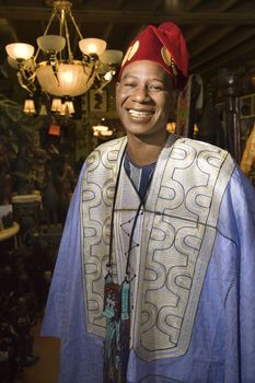 Portrait of smiling mid-adult African-American man wearing traditional African clothing.