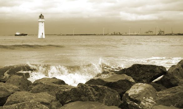 Old dissused lighthouse on a stormy day in sepia