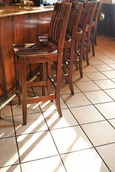 Chairs lined up at bar in nightclub or restaurant.