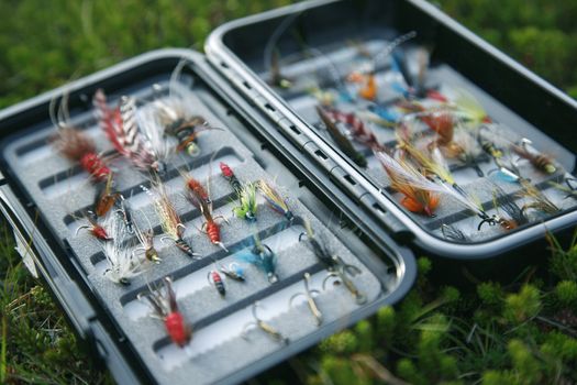 Flyfishing box full of colorful flies - short depth of field