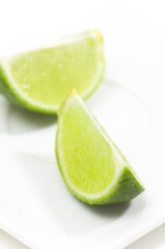 Fresh limes on white plate