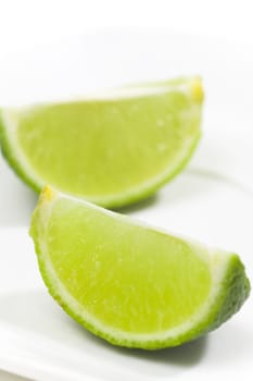 Fresh limes on white plate