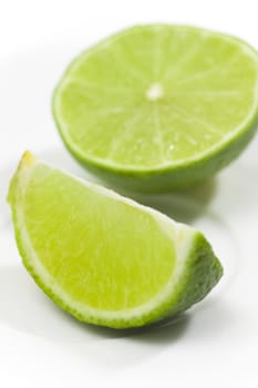 Fresh limes on white plate