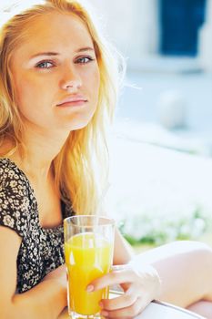 Young attractive woman with a glass of orange juice