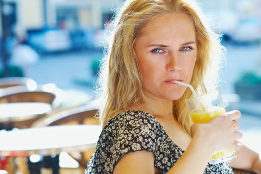 Young attractive woman with a glass of orange juice