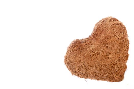 A heart made of straw on a white background