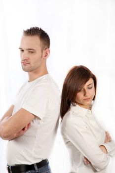 Young couple fights. Both people stand back to back and look sad