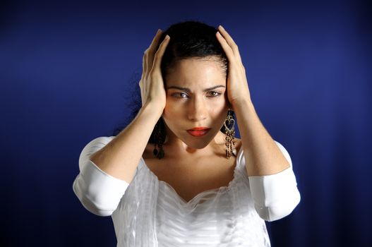 Portrait of serious hispanic woman with hands on the head