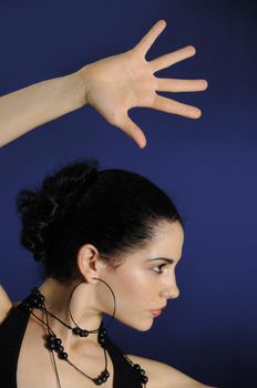 Portrait of young hispanic female model with open hand 