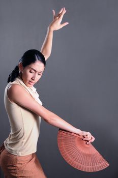 Portrait of hispanic flamenco dancer woman with traditional fan