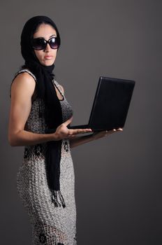 Portrait of young fashion female holding laptop