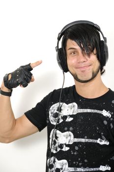 Portrait of young trendy hispanic male pointing to headphones - isolated
