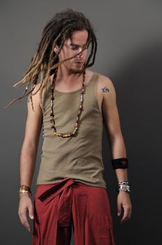 Portrait of young funky male with long dreadlocks