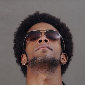 Portrait of young handsome african male with sunglasses