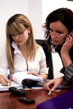 two attractive colleagues working as a team