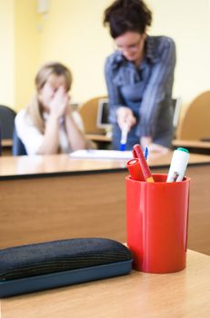 young teacher helping student with lessons