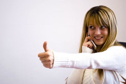 young businesswoman showing thumb up
