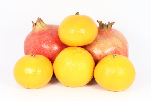 Mandarine and pomegranate isolated on white
