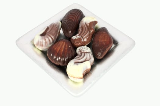 Sweet chocolate candies in the form of marine shellfish isolated on white