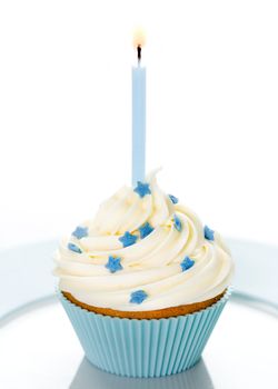 Blue birthday cupcake on a white plate